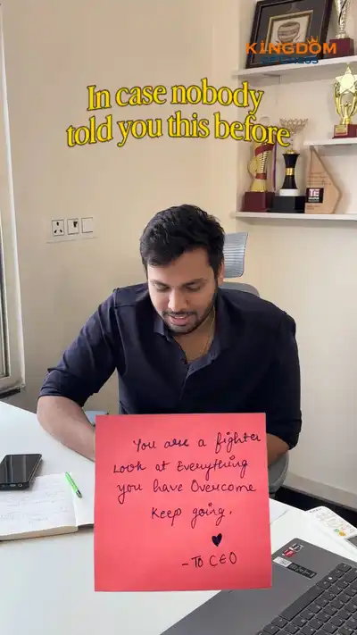 A handwritten note held up at a desk, trophies on the shelves behind