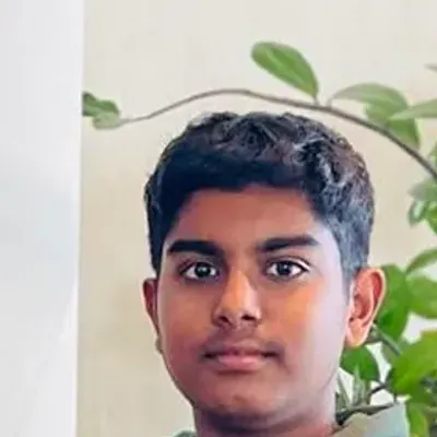 Kingdom of Chess student Aditya Eshwaran in the academy polo